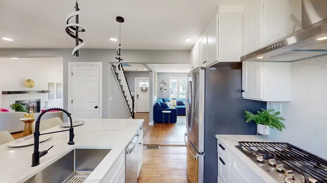 a very nice looking room with wooden floor and furniture