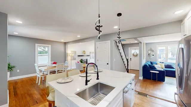 a living room with kitchen island furniture and a chandelier