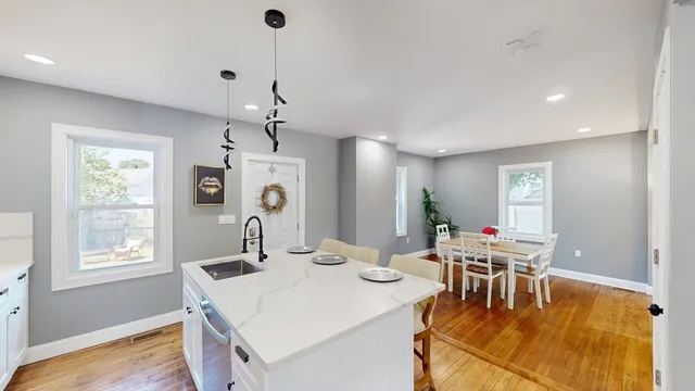 a dining room with furniture window and wooden floor