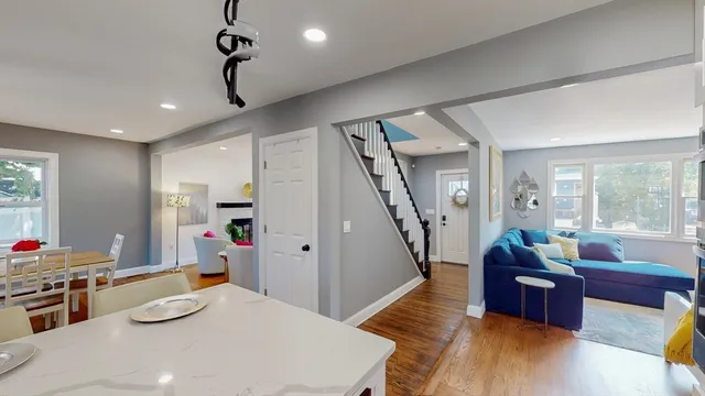 a living room with furniture and a wooden floor