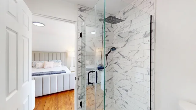 a bathroom with a bathtub and shower