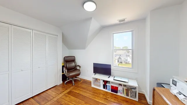 a view of a workspace with furniture and a window