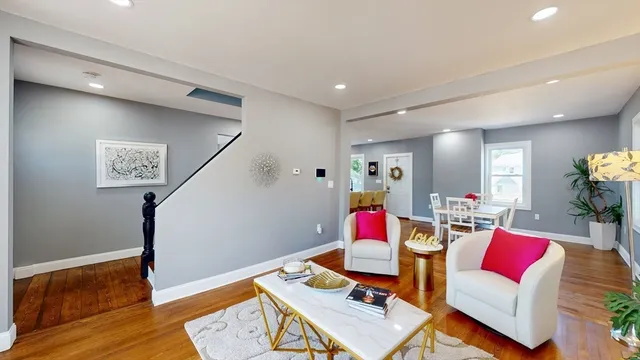 a living room with furniture and wooden floor