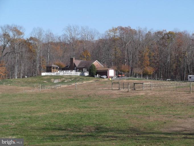 8344 Settle School Road Rixeyville, VA 22737 - Photo 2 of 30 a backyard of a house with table and chairs