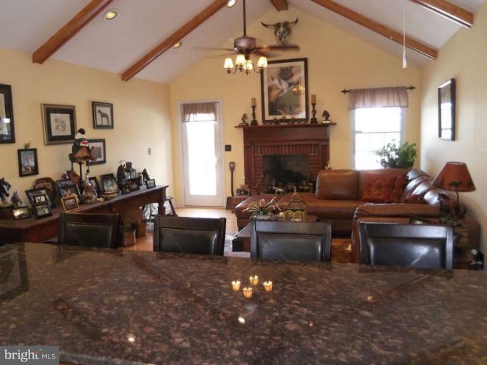 8344 Settle School Road Rixeyville, VA 22737 - Photo 24 of 30 a living room with furniture a fireplace and a chandelier