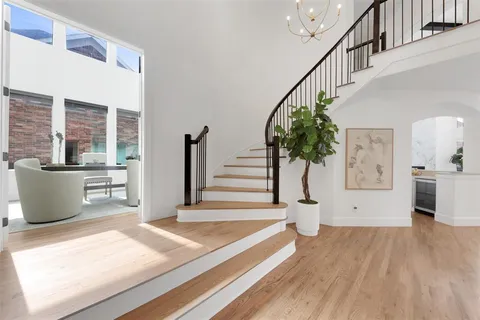 a view of entryway and hall with wooden floor
