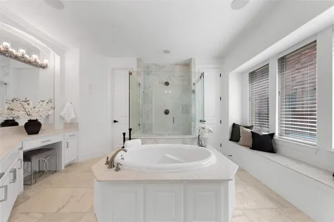 a bathroom with a bathtub sink and mirror