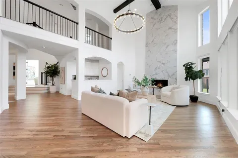 a living room with furniture and a chandelier