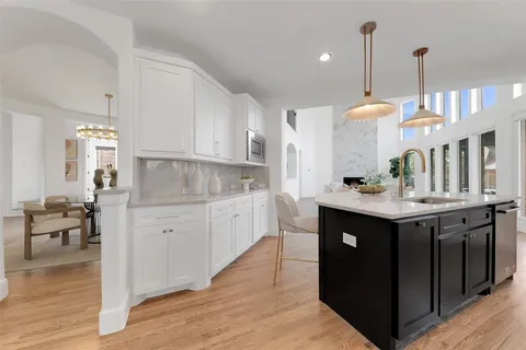 a kitchen with stainless steel appliances granite countertop a sink and a stove