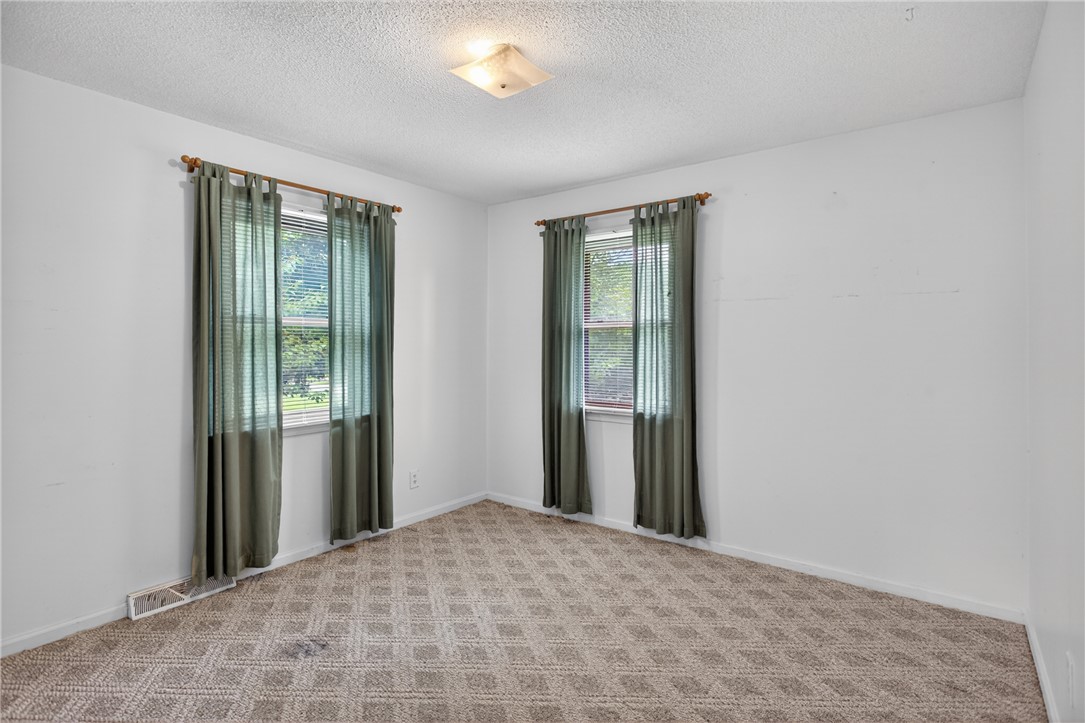 112 Holliday Lane Pendleton, SC 29670 - Photo 24 of 42 A well-proportioned room featuring patterned carpet and ample natural light through two windows.