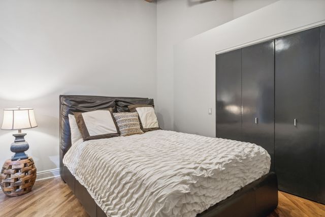 a bedroom with a bed and a night stand