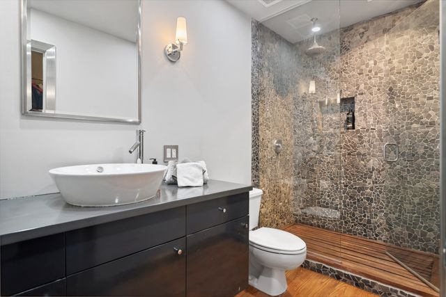 a bathroom with a sink toilet and a mirror