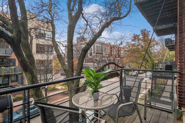 a view of a balcony dining table and chairs