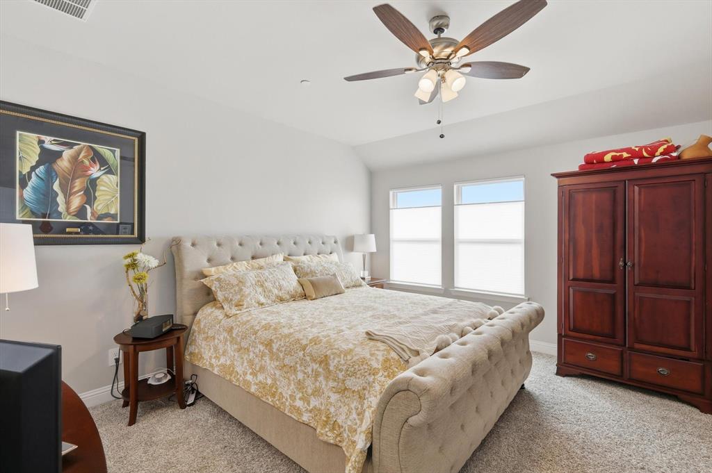 6092 Bursey Road Watauga, TX 76148 - Photo 16 of 23 a bedroom with a bed and a chandelier