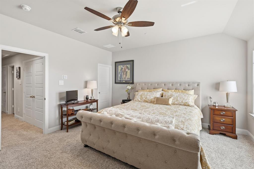6092 Bursey Road Watauga, TX 76148 - Photo 17 of 23 a bedroom with a bed and a chandelier