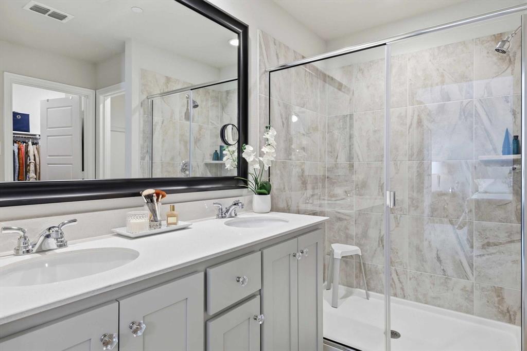 6092 Bursey Road Watauga, TX 76148 - Photo 18 of 23 a bathroom with a double vanity sink mirror and shower