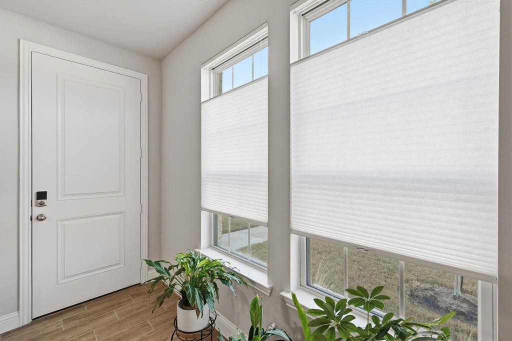 6092 Bursey Road Watauga, TX 76148 - Photo 6 of 23 a view of a balcony with chair and wooden floor