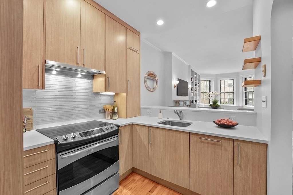 125 Beacon Street, Unit 5 Boston, MA 02116 - Photo 2 of 13 a kitchen with stainless steel appliances granite countertop a sink and a stove