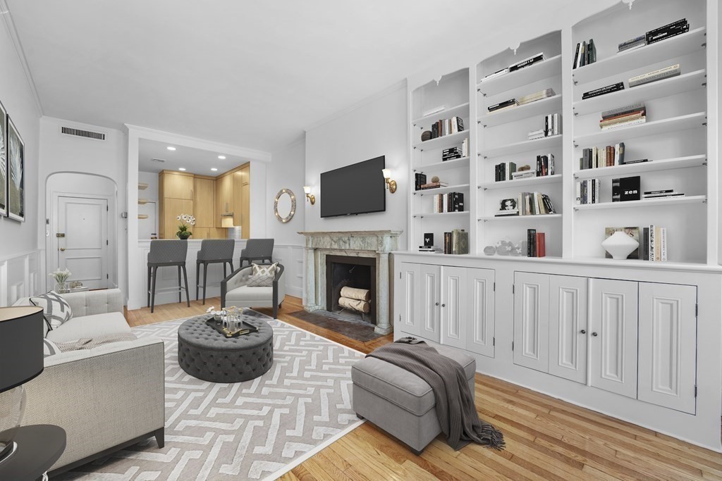 125 Beacon Street, Unit 5 Boston, MA 02116 - Photo 5 of 13 a living room with furniture a fireplace and a flat screen tv
