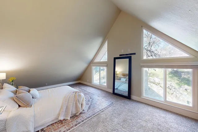 a view of a livingroom with furniture and staircase