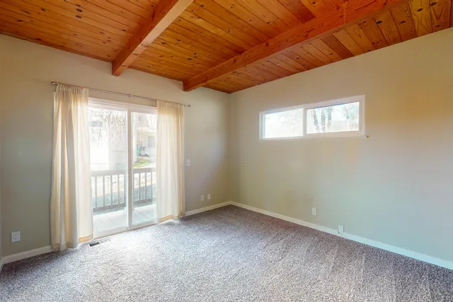 a view of a livingroom with an empty space and a window