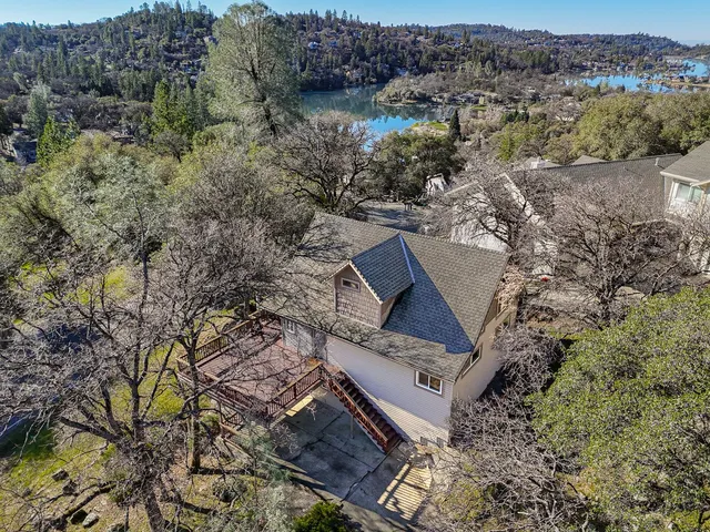 an aerial view of house with yard and mountain view
