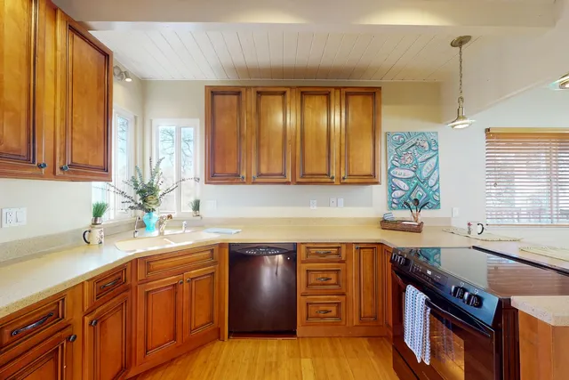 a kitchen with a sink stove and cabinets
