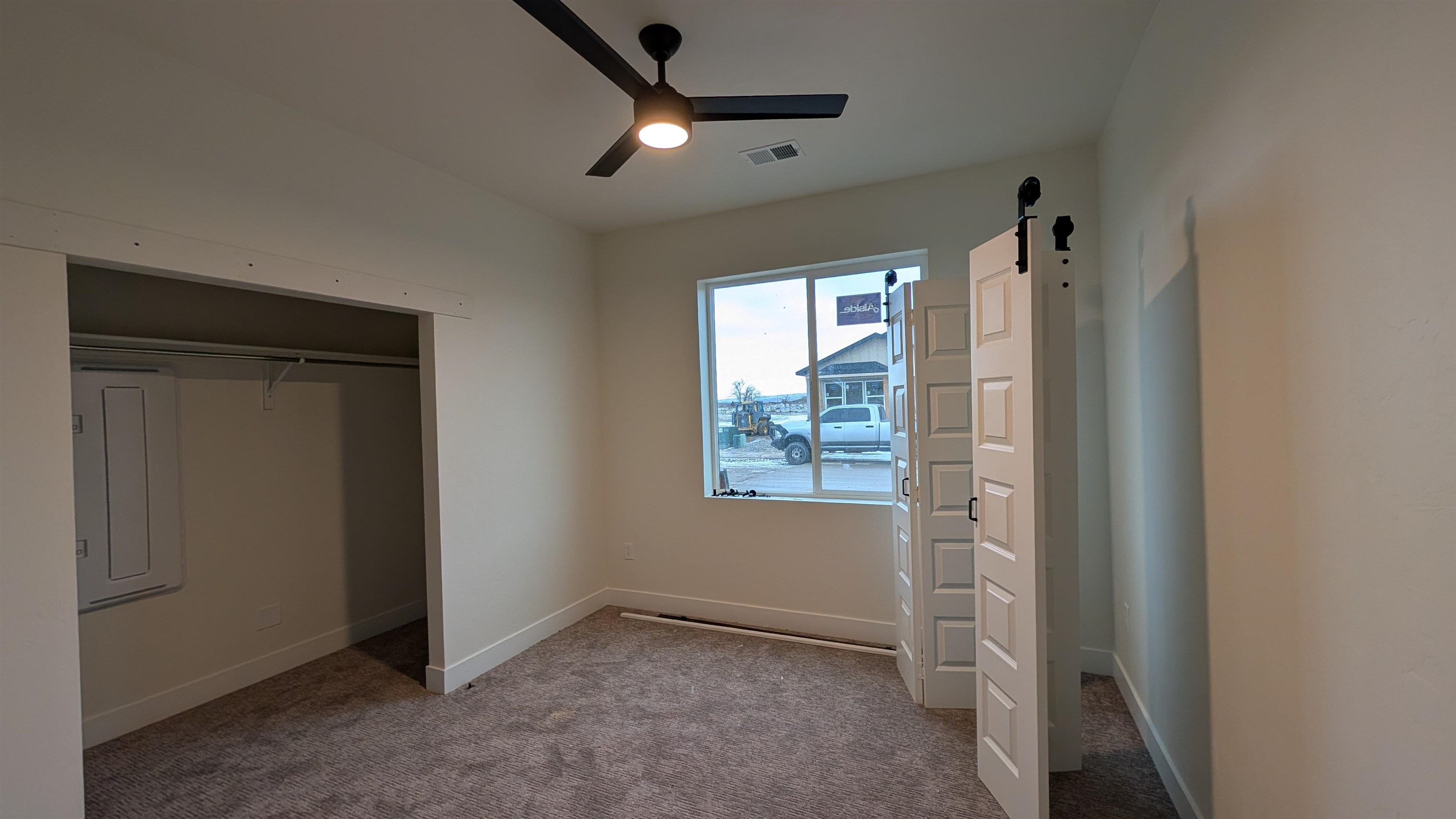 2474 Revere Road Grand Junction, CO 81505 - Photo 8 of 13 an empty room with windows and fan