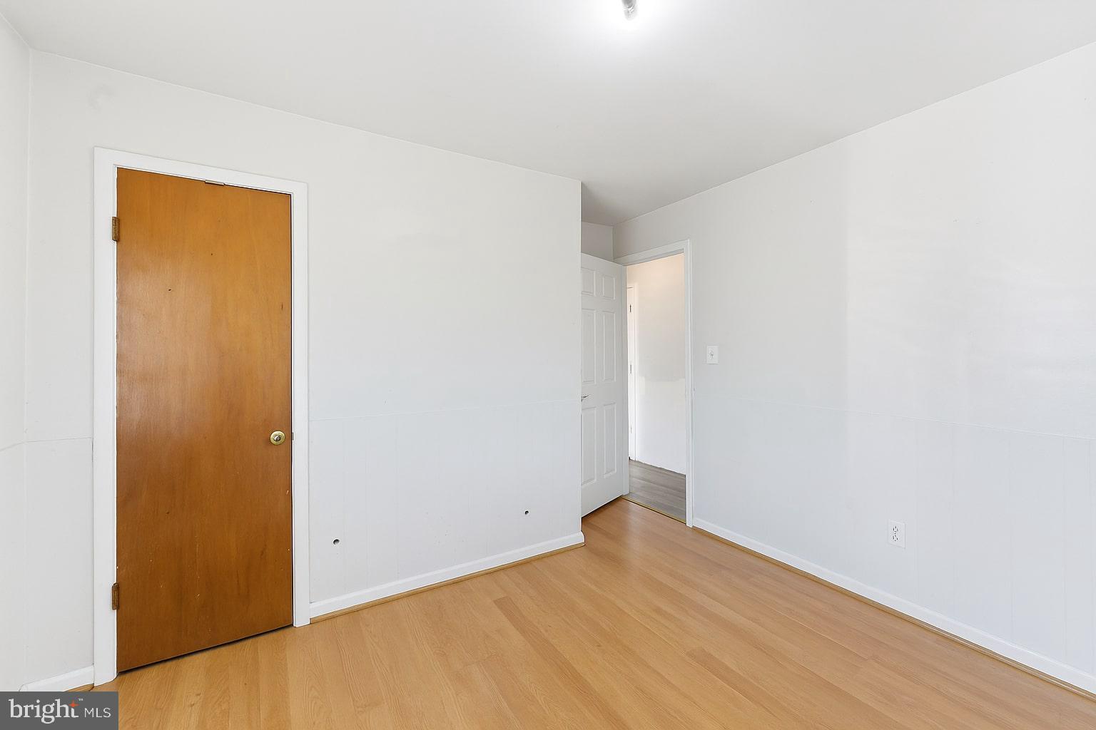 7812 Amherst Drive Manassas, VA 20111 - Photo 14 of 36 a view of an empty room with wooden floor and a window