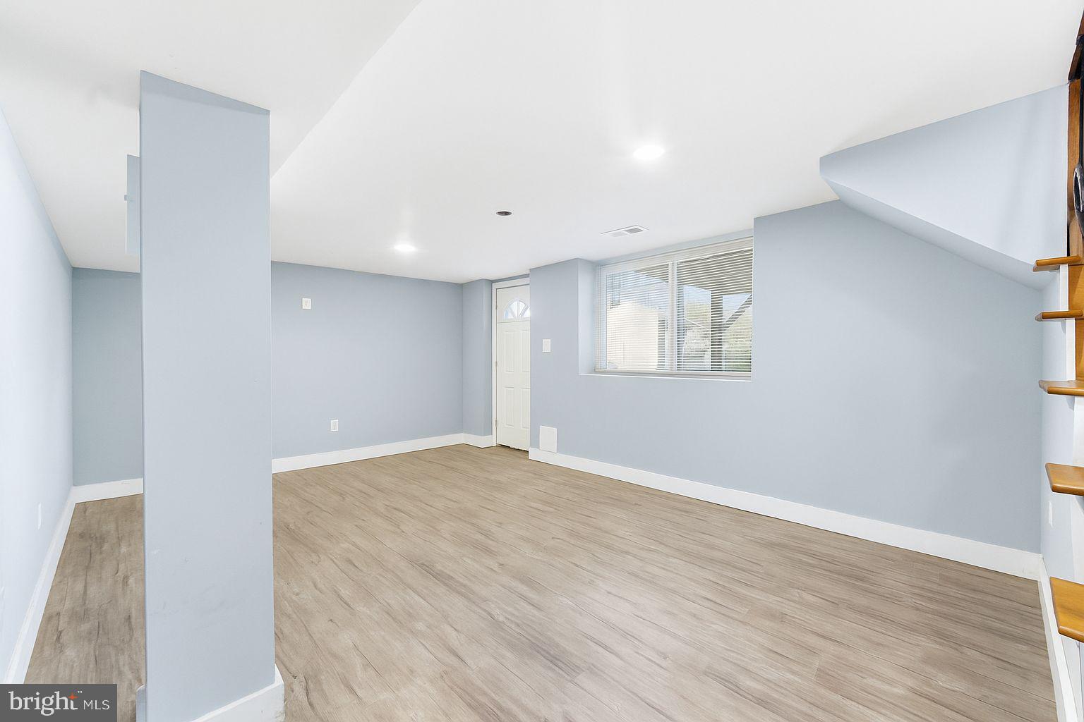 7812 Amherst Drive Manassas, VA 20111 - Photo 18 of 36 a view of an empty room with wooden floor and a window