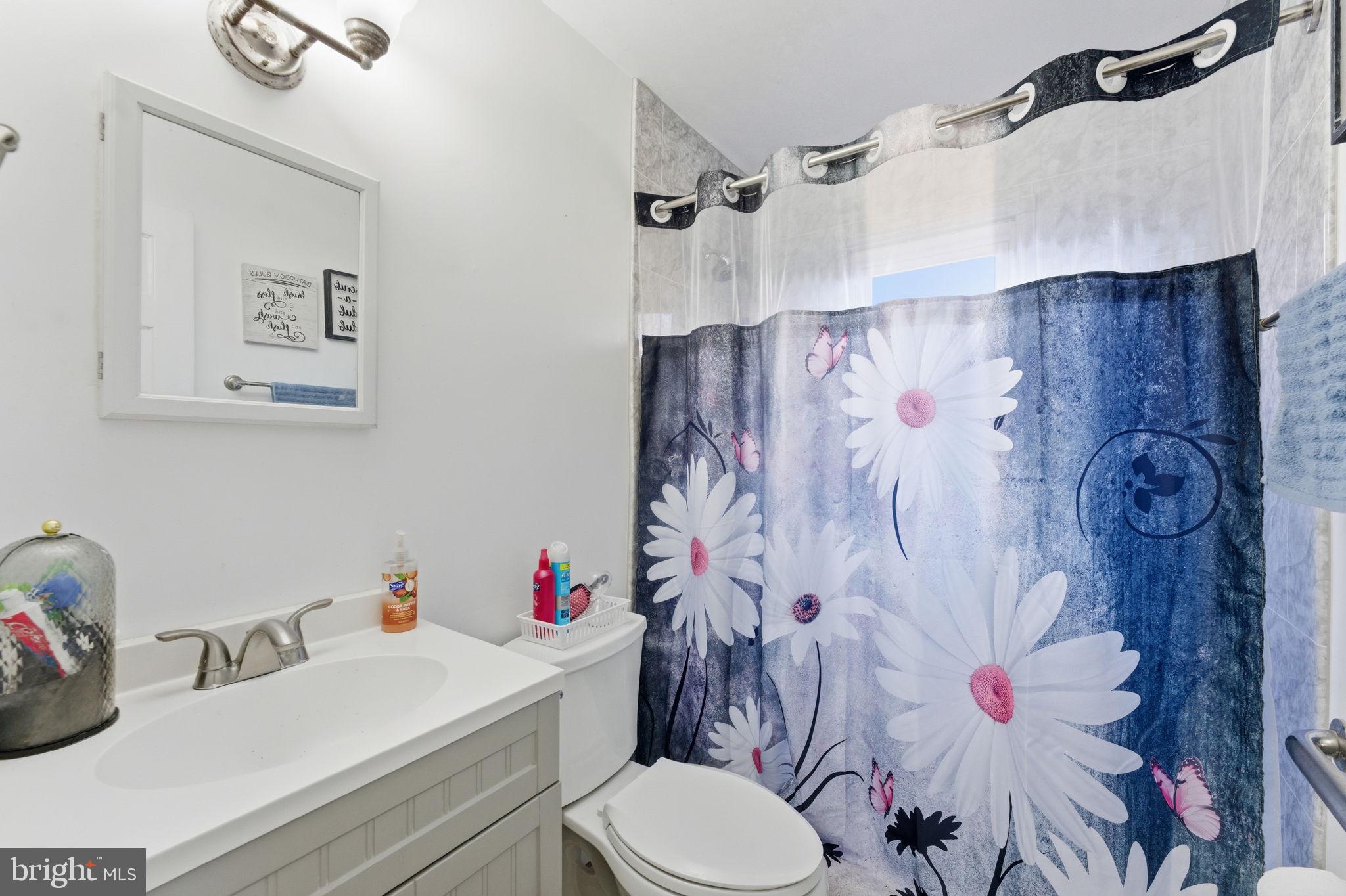7812 Amherst Drive Manassas, VA 20111 - Photo 22 of 36 a bathroom with a sink toilet and shower curtain