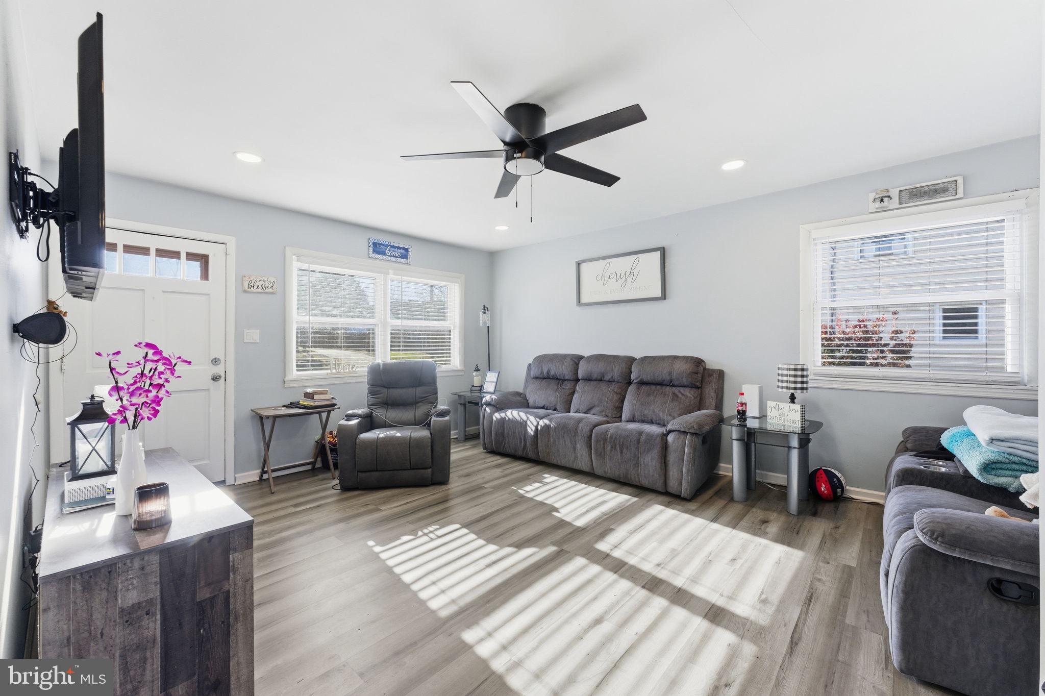 7812 Amherst Drive Manassas, VA 20111 - Photo 3 of 36 a living room with furniture and a flat screen tv