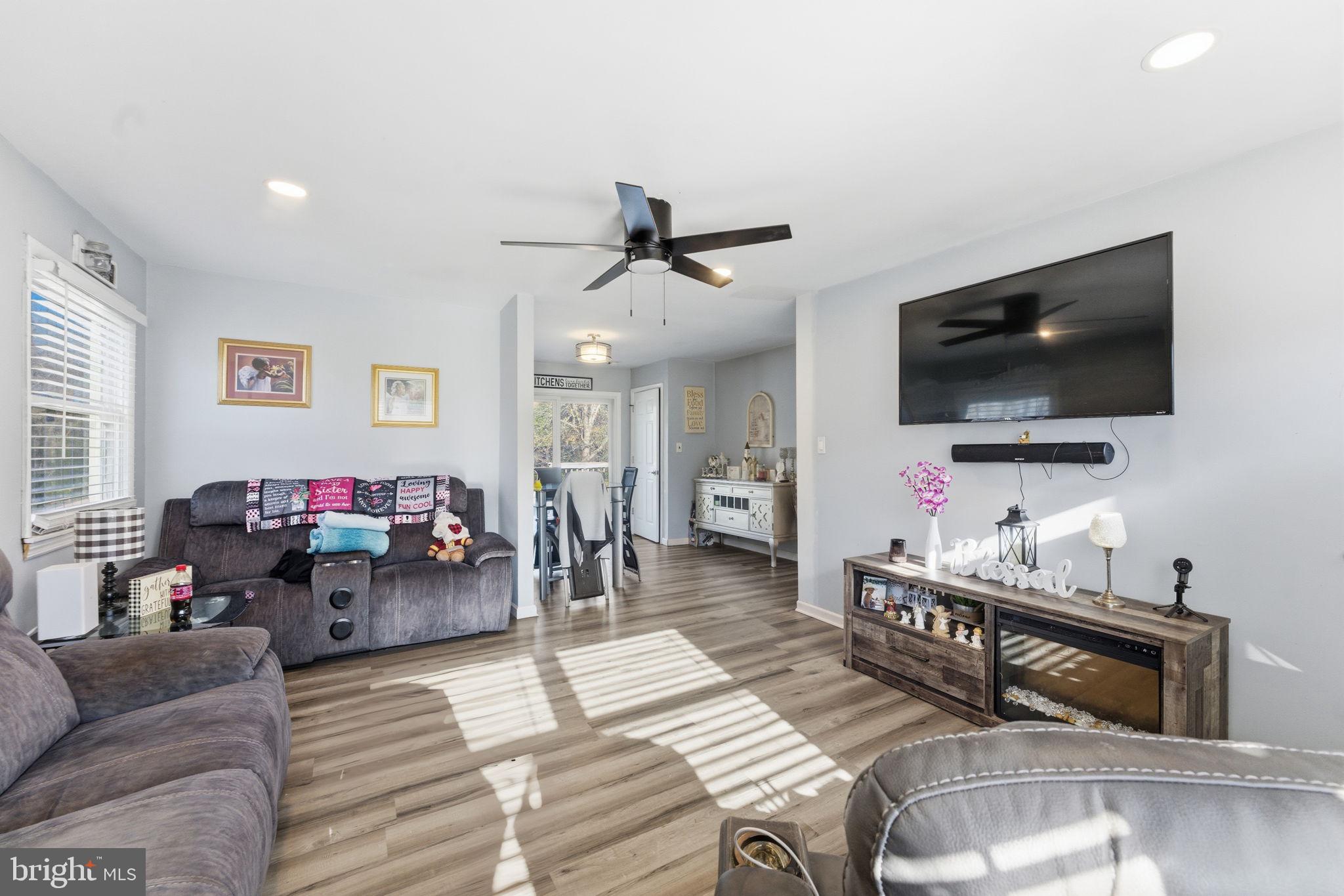 7812 Amherst Drive Manassas, VA 20111 - Photo 4 of 36 a living room with furniture and a flat screen tv