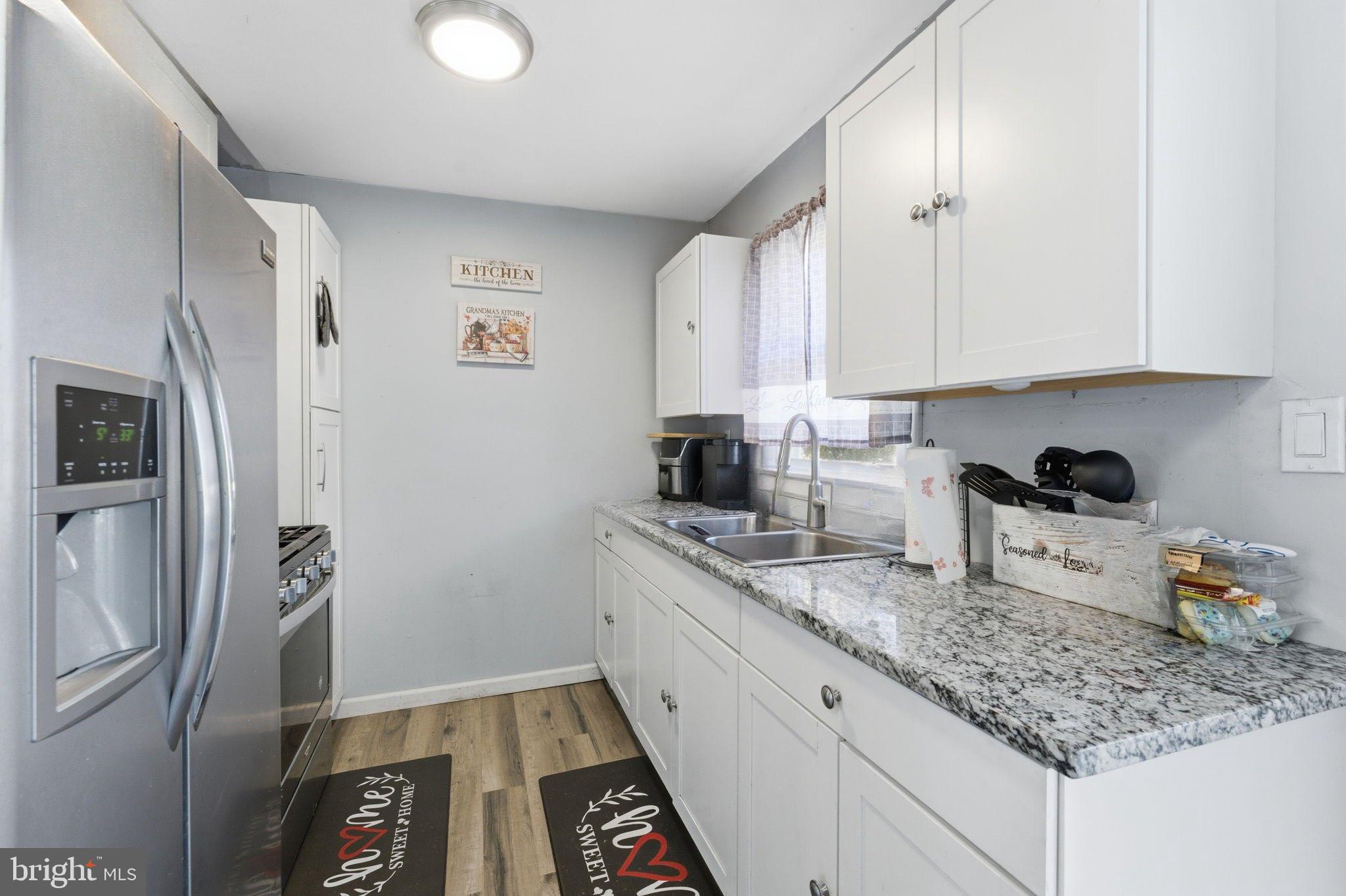 7812 Amherst Drive Manassas, VA 20111 - Photo 8 of 36 a kitchen with stainless steel appliances granite countertop a refrigerator sink and stove