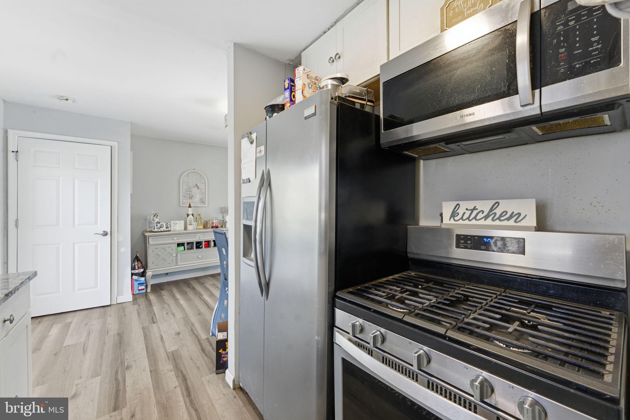 7812 Amherst Drive Manassas, VA 20111 - Photo 9 of 36 a kitchen with stainless steel appliances granite countertop a refrigerator and a stove top oven