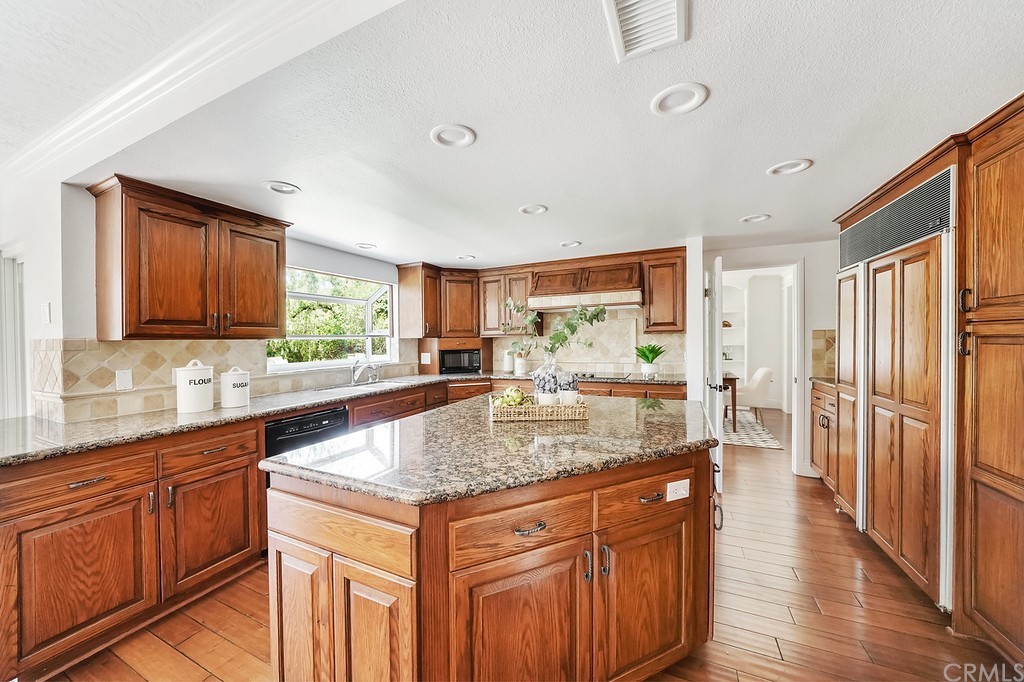 1902 Derby Drive North Tustin, CA 92705 - Photo 18 of 67 a kitchen with stainless steel appliances granite countertop a sink stove and refrigerator