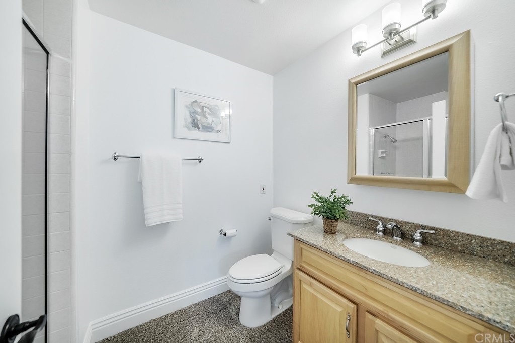 1902 Derby Drive North Tustin, CA 92705 - Photo 26 of 67 a bathroom with a granite countertop toilet sink and mirror