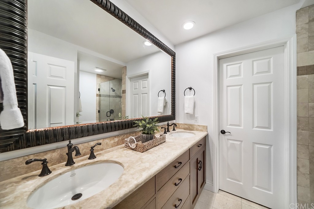 1902 Derby Drive North Tustin, CA 92705 - Photo 30 of 67 a bathroom with double vanity sinks and a mirror