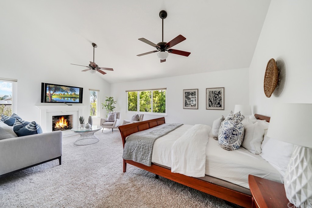 1902 Derby Drive North Tustin, CA 92705 - Photo 32 of 67 a bedroom with a bed and ceiling fan