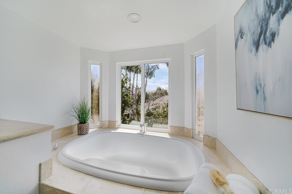 1902 Derby Drive North Tustin, CA 92705 - Photo 38 of 67 a spacious bedroom with a large bed and a potted plant