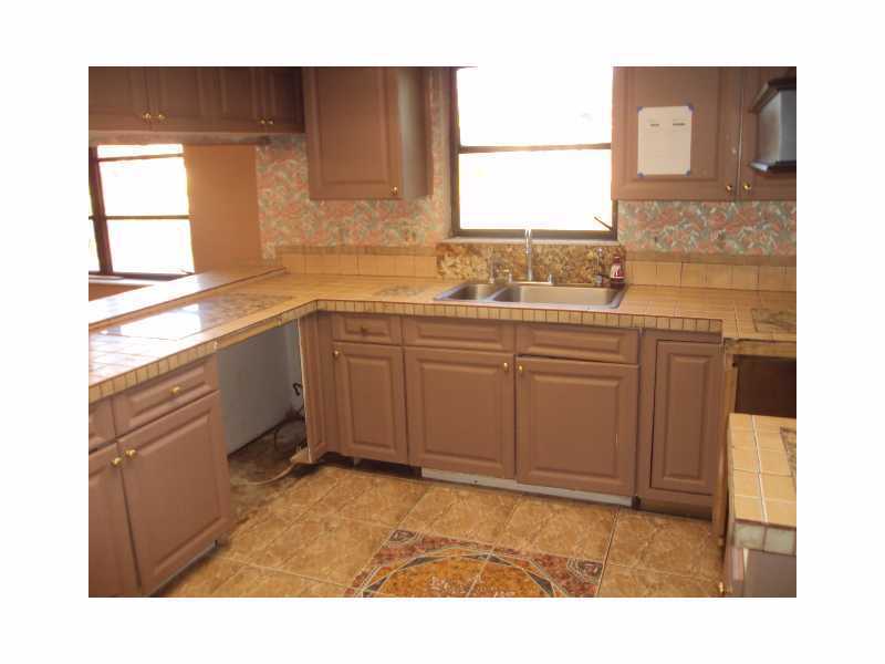 1758 Mistletoe Street Sebastian, FL 32958 - Photo 5 of 13 a kitchen with a sink cabinets and a window