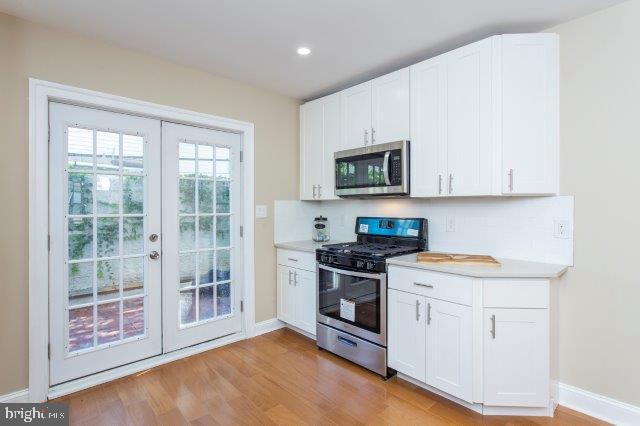2026 McClellan Street Philadelphia, PA 19145 - Photo 12 of 32 a kitchen with stainless steel appliances granite countertop a stove a sink and a microwave