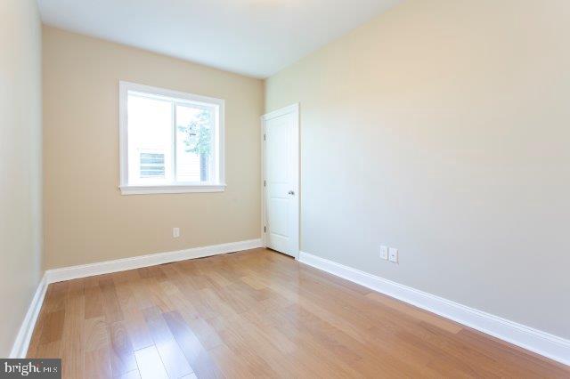 2026 McClellan Street Philadelphia, PA 19145 - Photo 18 of 32 an empty room with wooden floor and windows