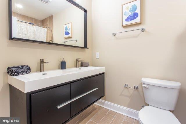 2026 McClellan Street Philadelphia, PA 19145 - Photo 19 of 32 a bathroom with a sink and a toilet