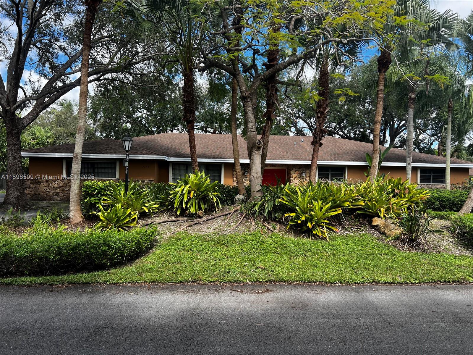 7751 Southwest 131st Street Pinecrest, FL 33156 - Photo 1 of 23 a house view with a garden space