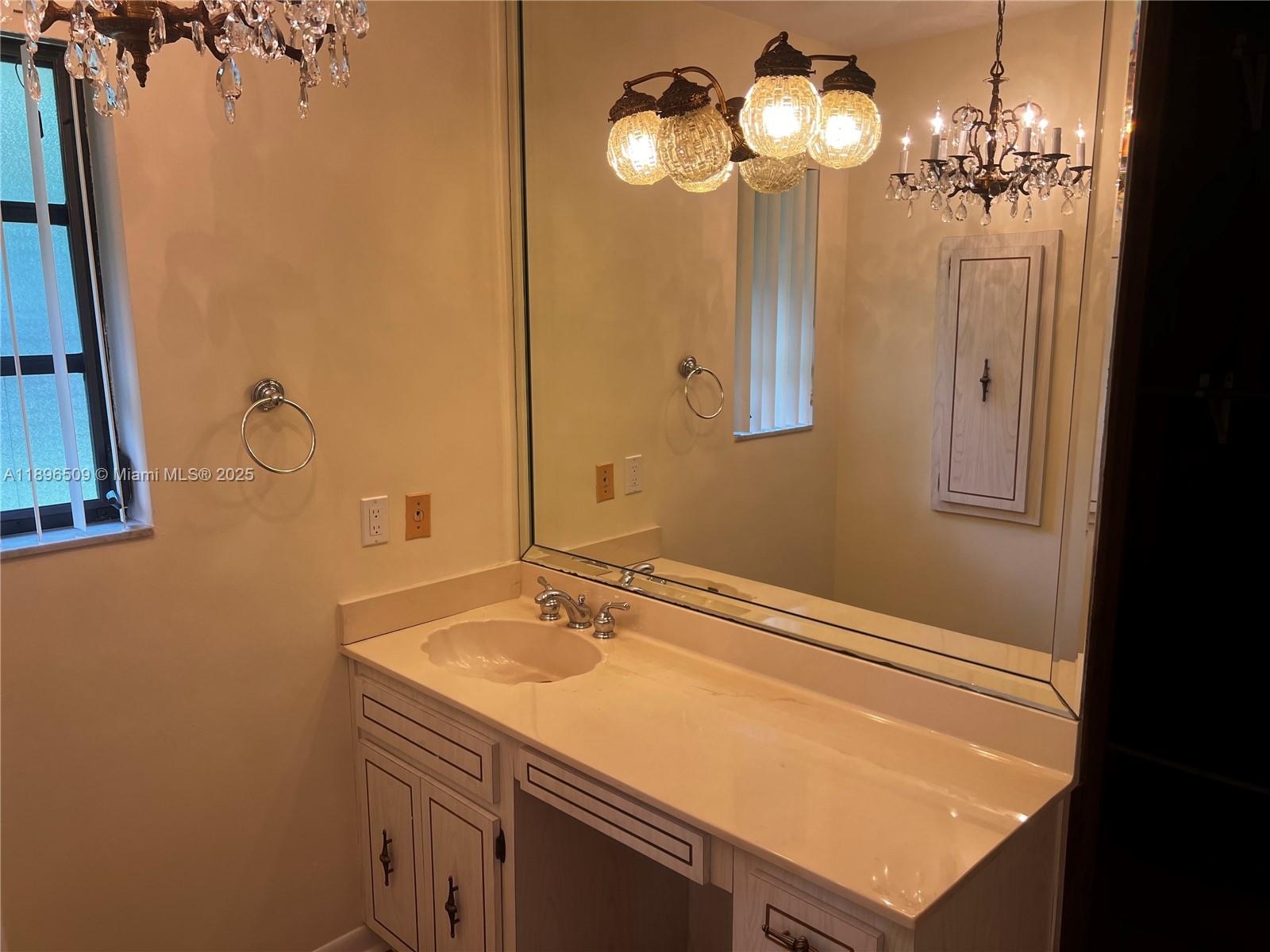 7751 Southwest 131st Street Pinecrest, FL 33156 - Photo 12 of 23 a bathroom with a sink and a mirror