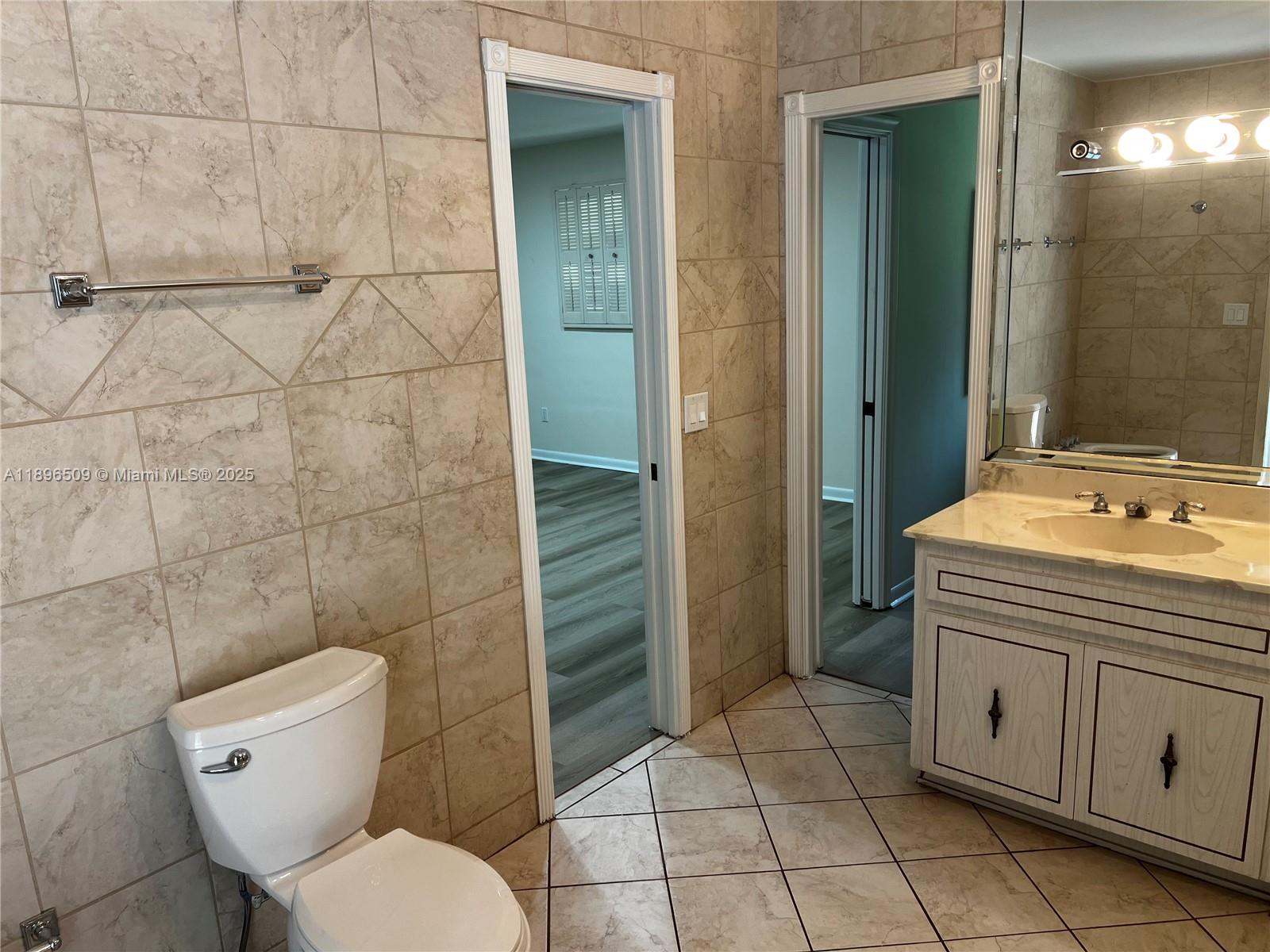 7751 Southwest 131st Street Pinecrest, FL 33156 - Photo 13 of 23 a bathroom with a toilet sink and shower