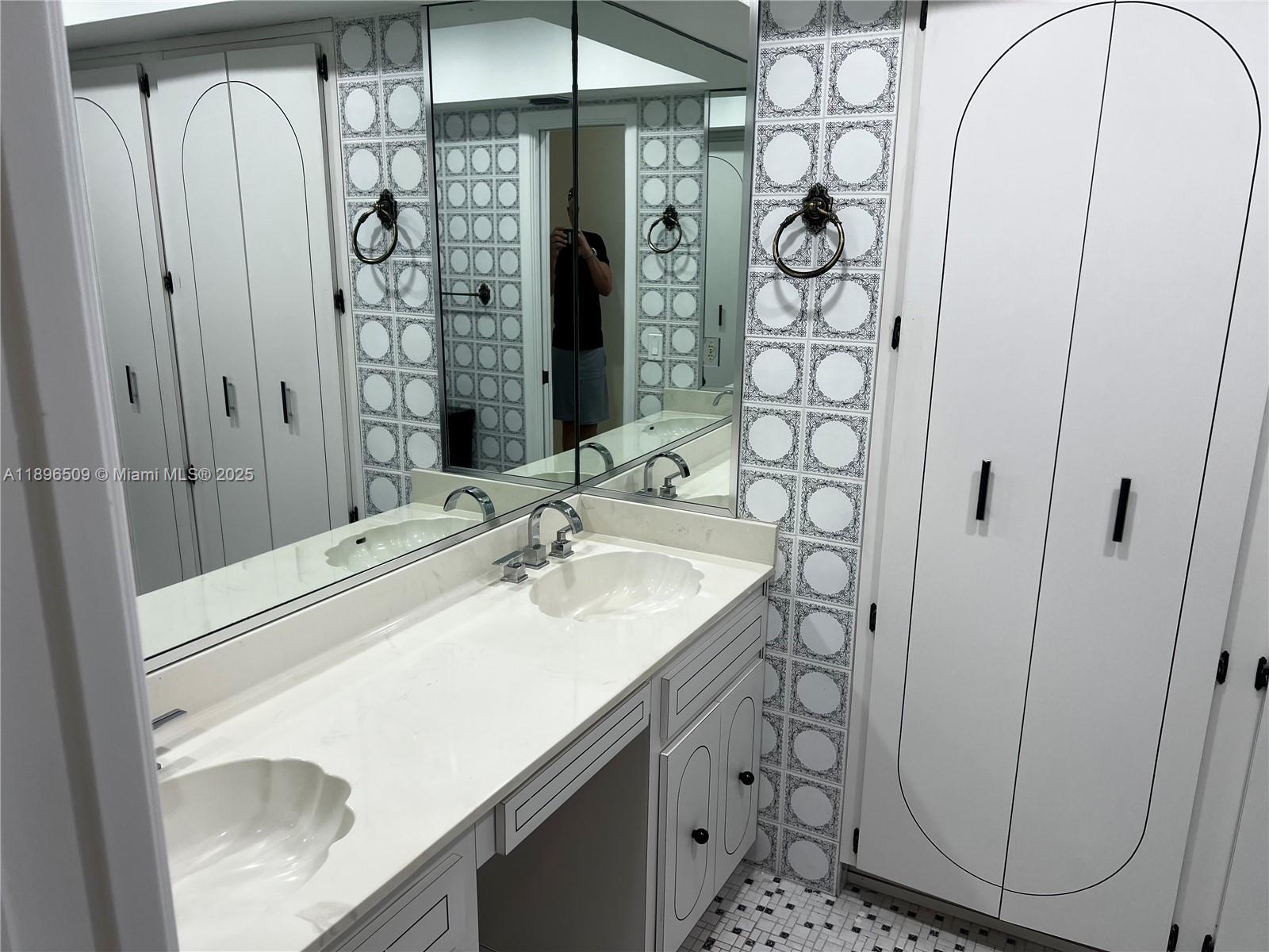 7751 Southwest 131st Street Pinecrest, FL 33156 - Photo 17 of 23 a bathroom with a sink a mirror and shower