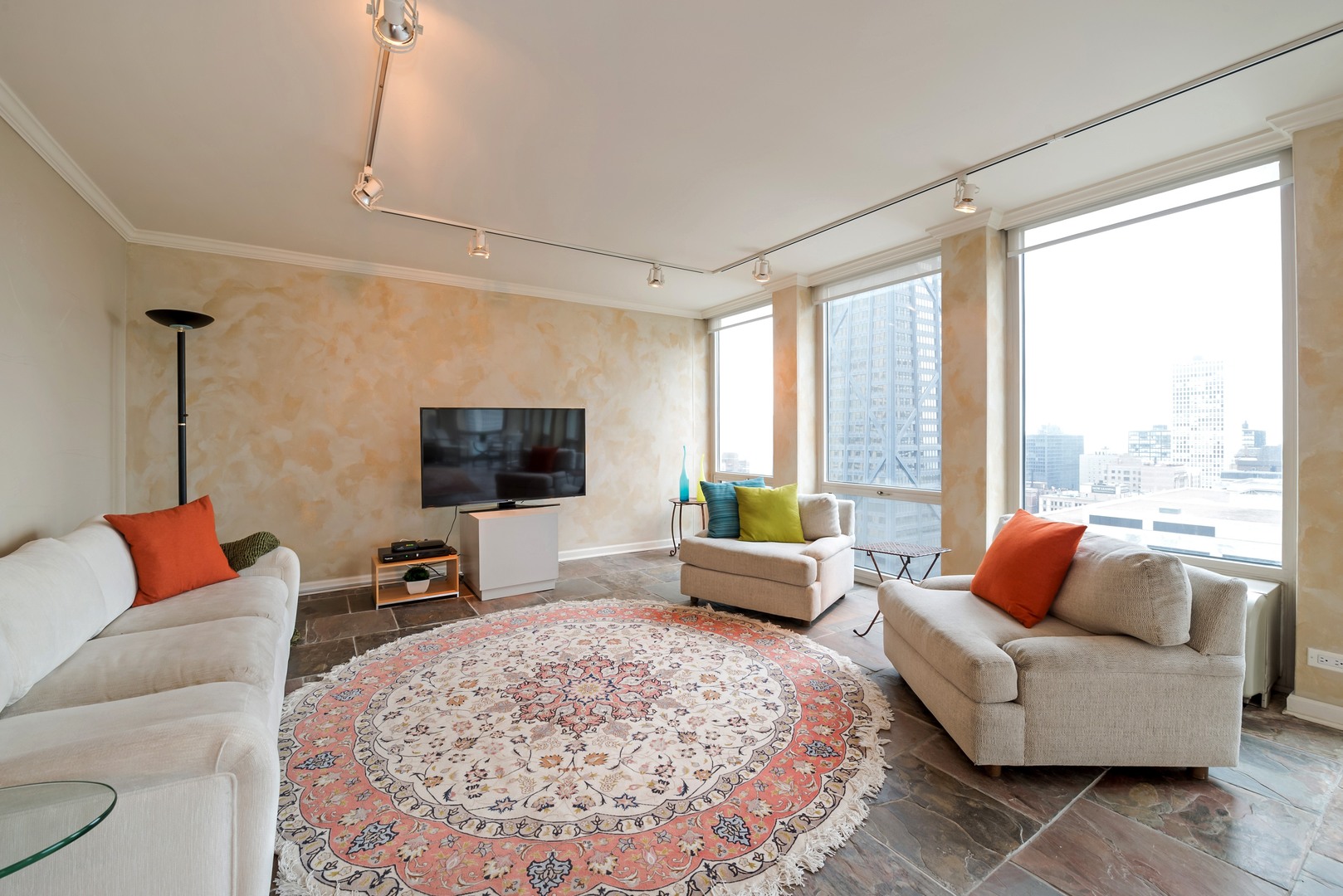 111 East Chestnut Street, Unit 29K Chicago, IL 60611 - Photo 3 of 10 a living room with furniture and a flat screen tv