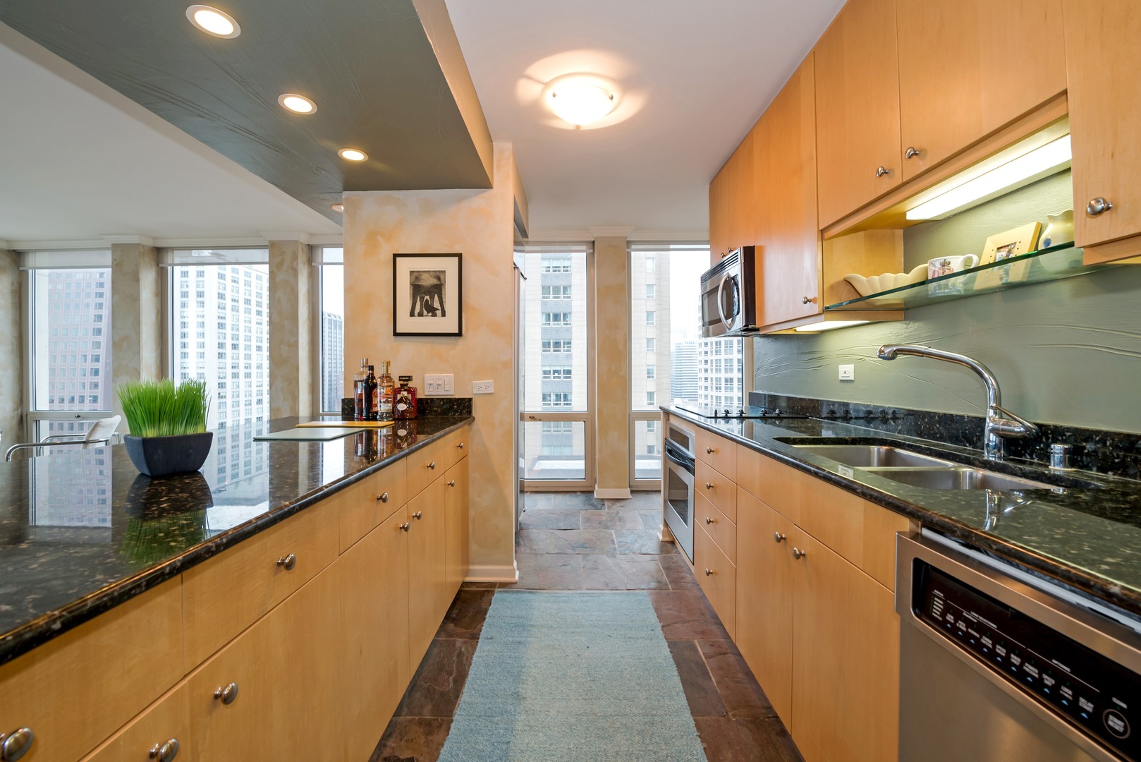 111 East Chestnut Street, Unit 29K Chicago, IL 60611 - Photo 4 of 10 a large kitchen with stainless steel appliances granite countertop a lot of counter space and a sink